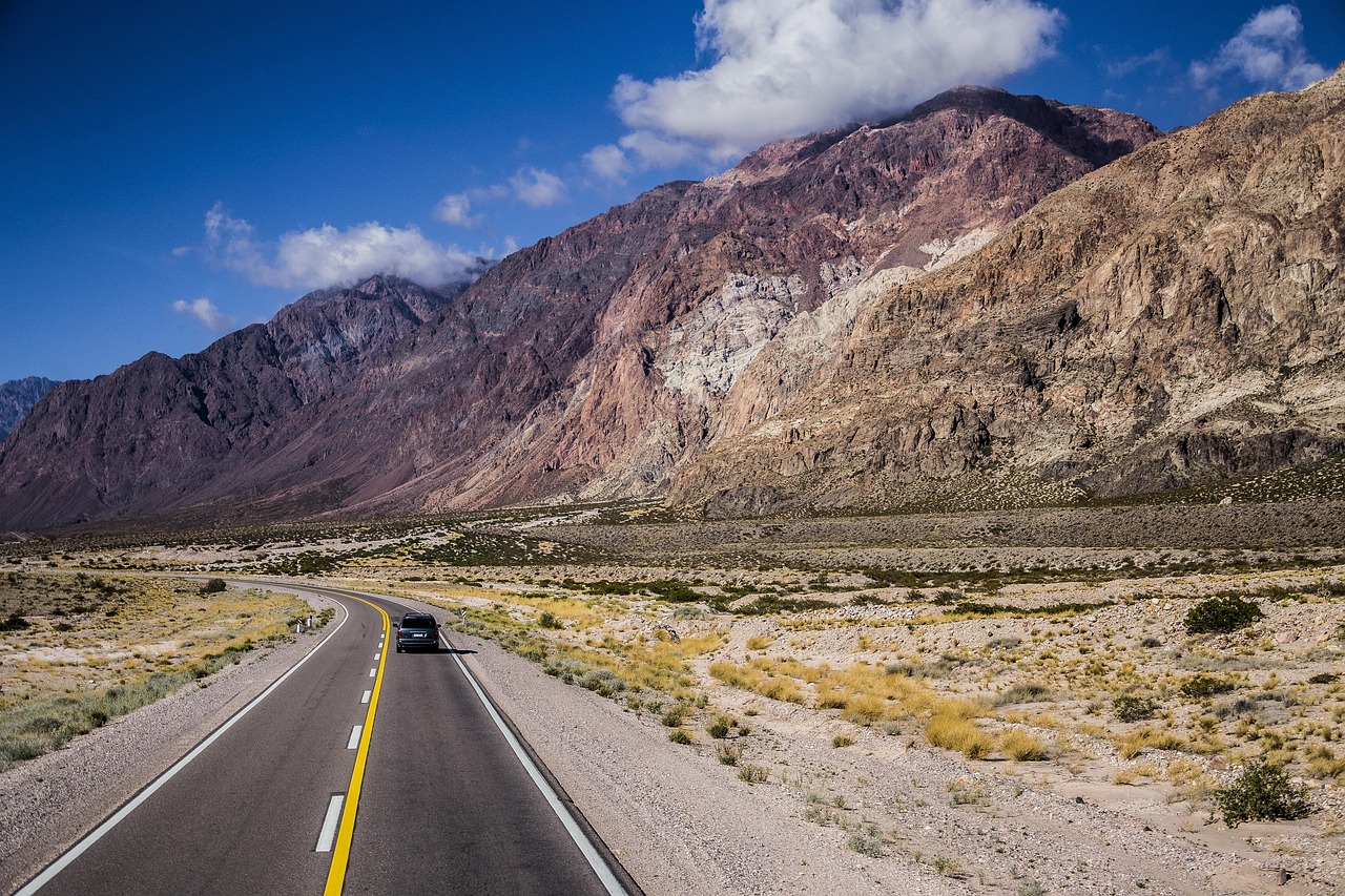 Car driving on an open mountain highway during a long road journey